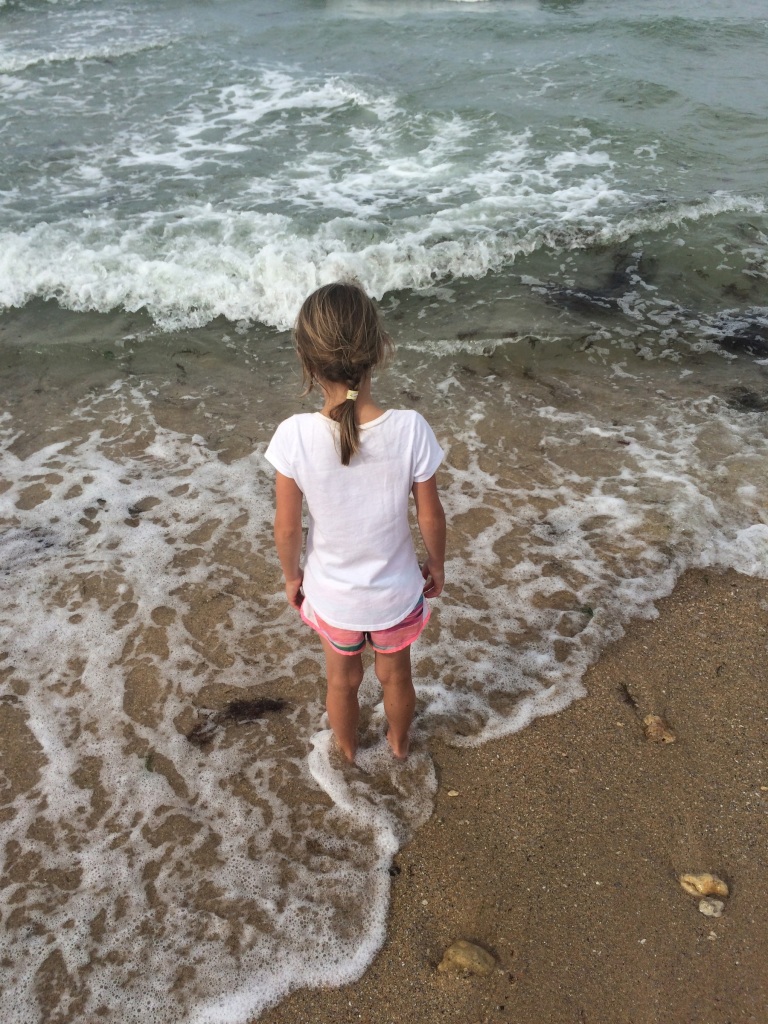 Danica dips her toes in the Atlantic for the first time, at Juno Beach.
